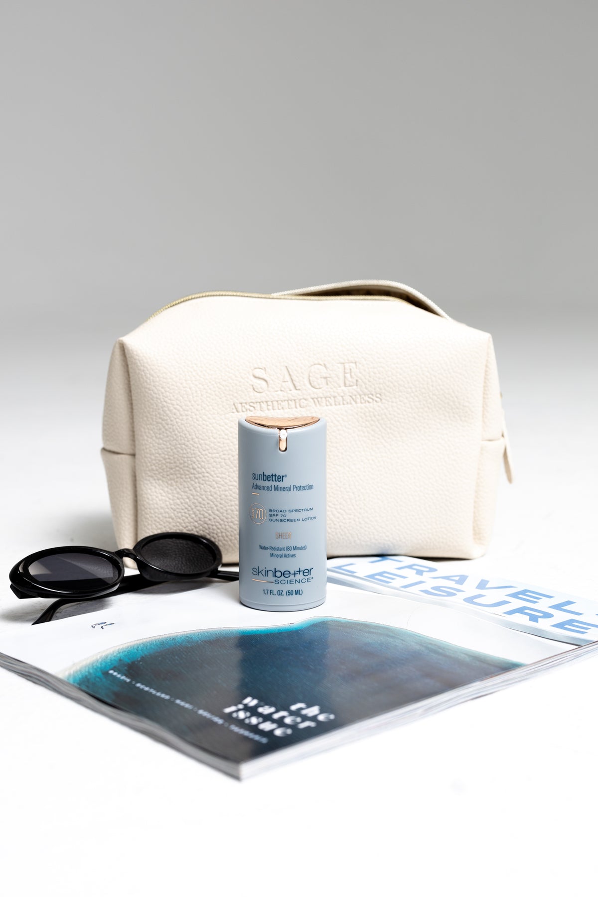 Beige skincare travel bag next to eyewear for stylish flat lay