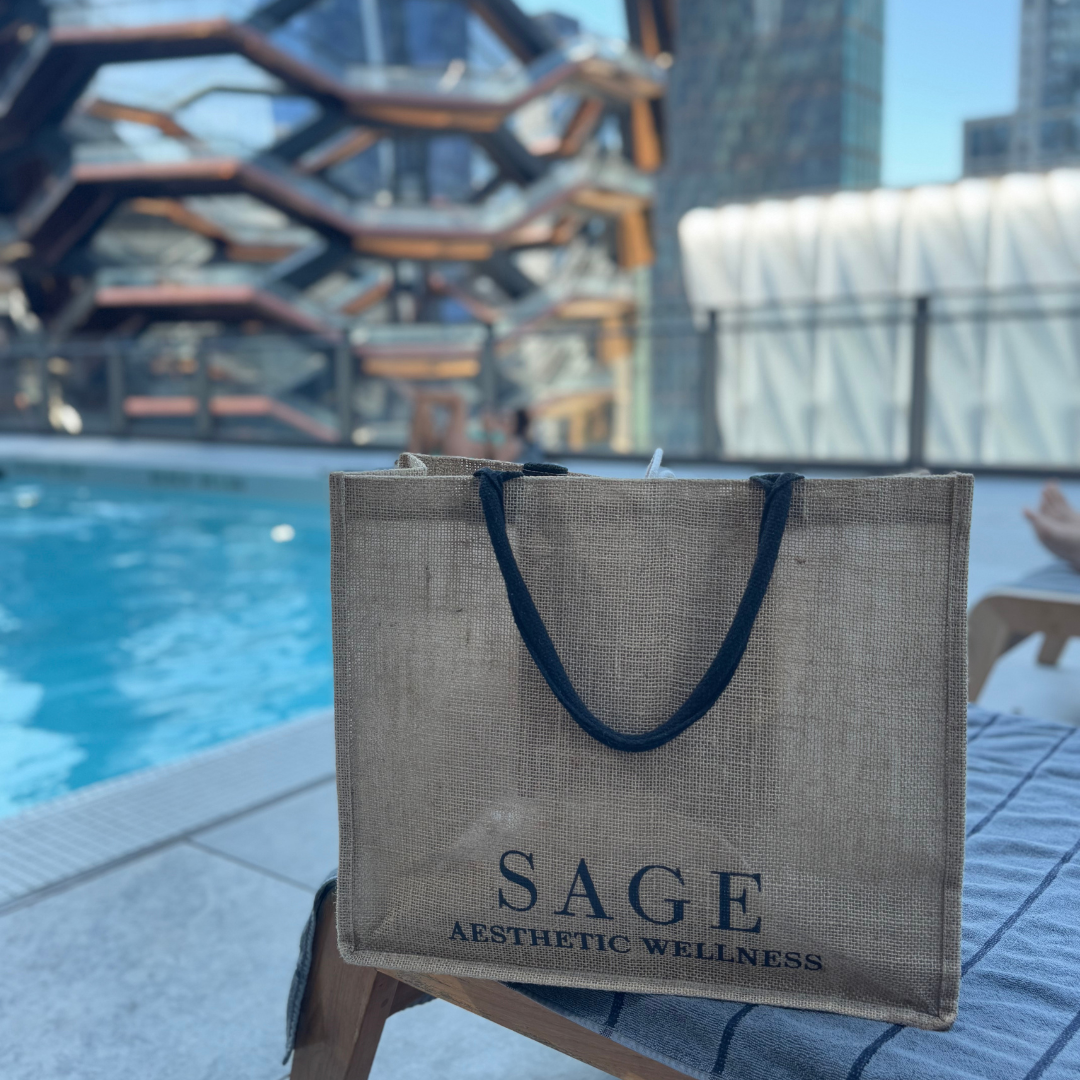 Sage Aesthetic Wellness tote bag by rooftop poolw ith Vessel NYC in background, featured for Scottsdale med spa lifestyle branding