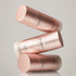 Three rose gold bottles of &