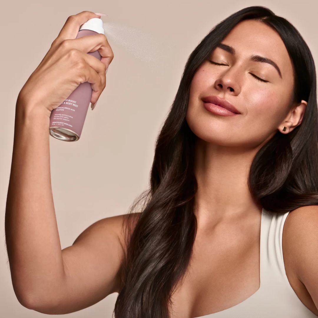Woman with clear glowing skin using hypochlorous acid face mist, fragrance-free vegan skincare for sensitive skin barrier support