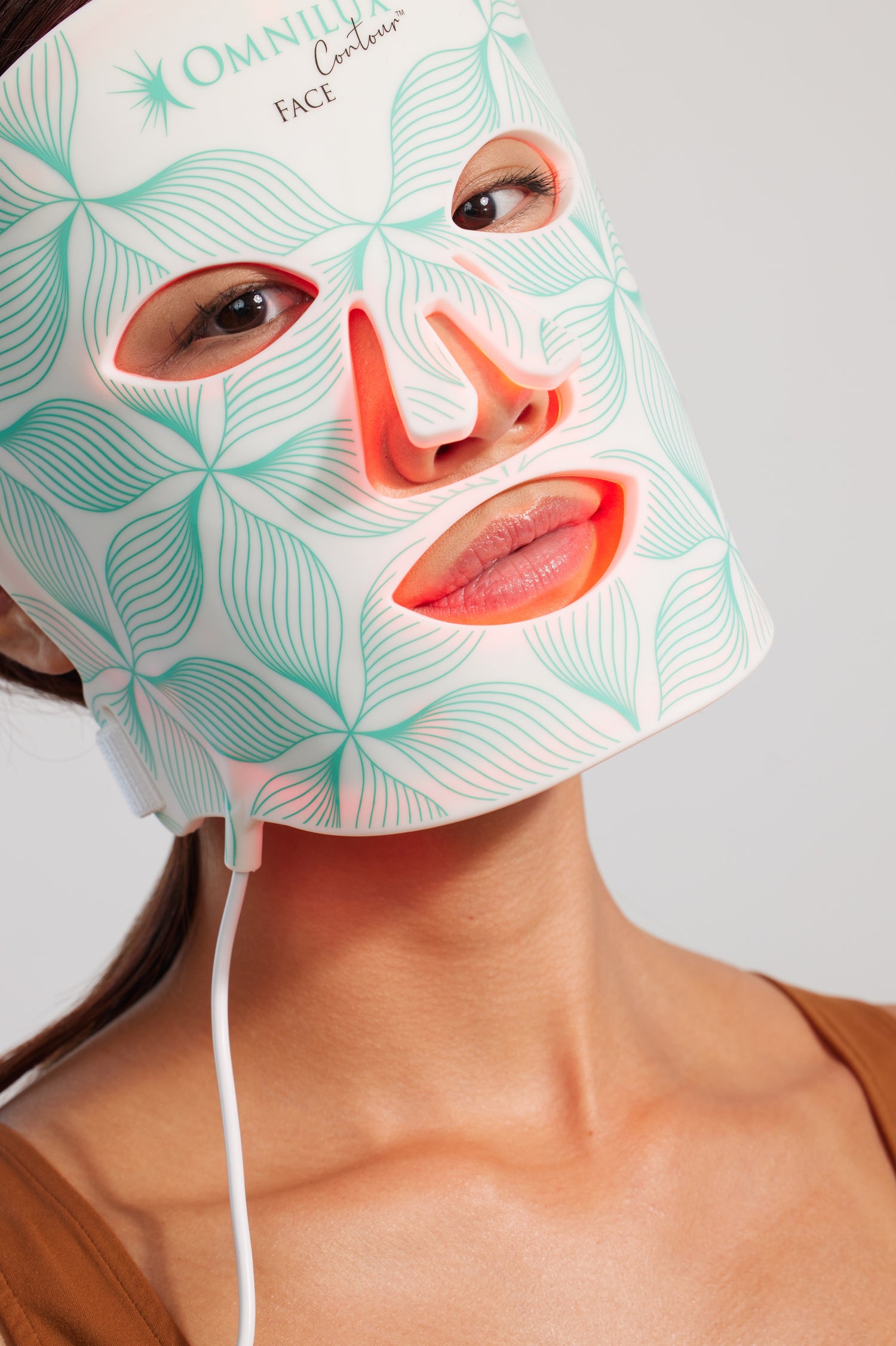 Model wearing Omnilux Contour FACE mask for skin firming and wrinkle reduction