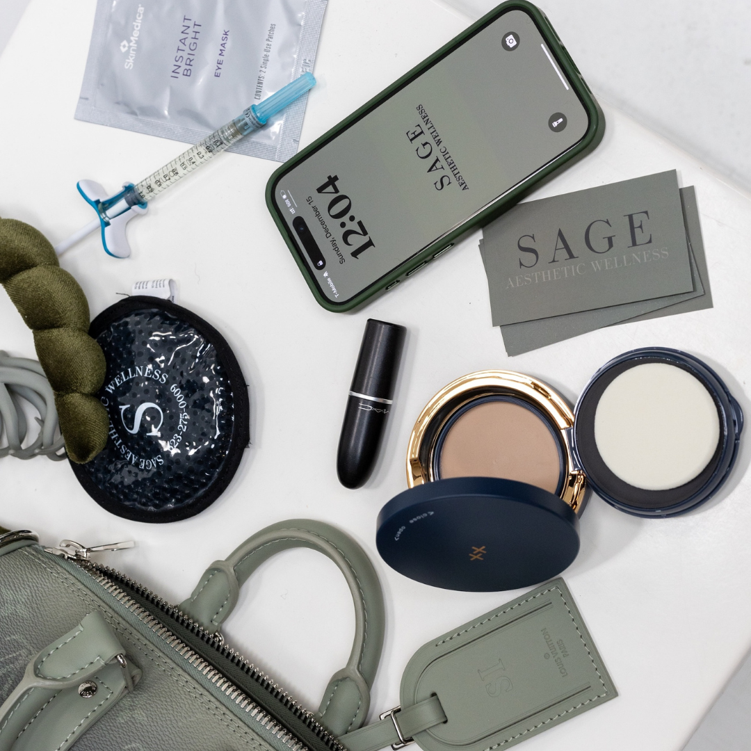 Flat lay of Sage Aesthetic Wellness branded items with syringe, makeup, and skincare tools in Scottsdale med spa